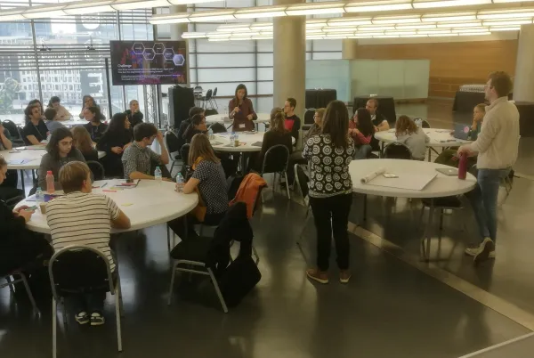 Conference delegates sitting around round tables and discussing